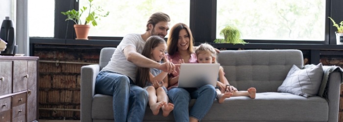 family smiling laughing at computer